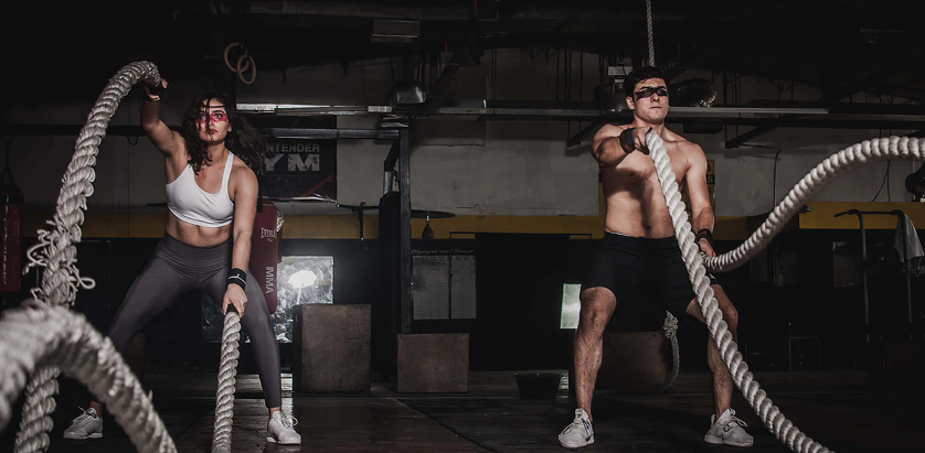 Athletes doing battle rope workout